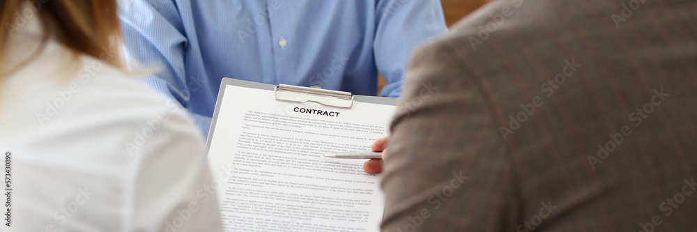 Married couple signs contract to buy house from male realtor or broker Married couple signs contract to buy house from male realtor or broker