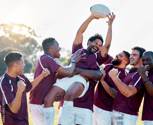 Sports, winner and rugby team with ball in celebration for winning match, game and sport competition. Fitness, teamwork and happy, excited athletes on field celebrate victory, success and motivation