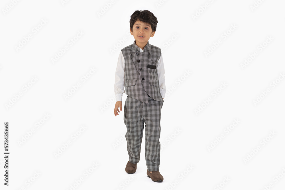 Portrait of a little boy standing against white background Portrait of a little boy standing against white background