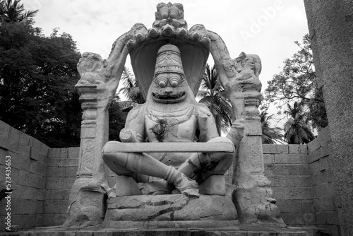 monolithic statue of Ugra Narsimha in Hampi. Monochrome picture taken at Unesco world heritage site in Karnataka state of India. photo