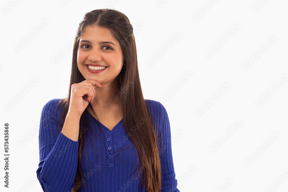Portrait of beautiful woman with hand on chin against white background Portrait of beautiful woman with hand on chin against white background
