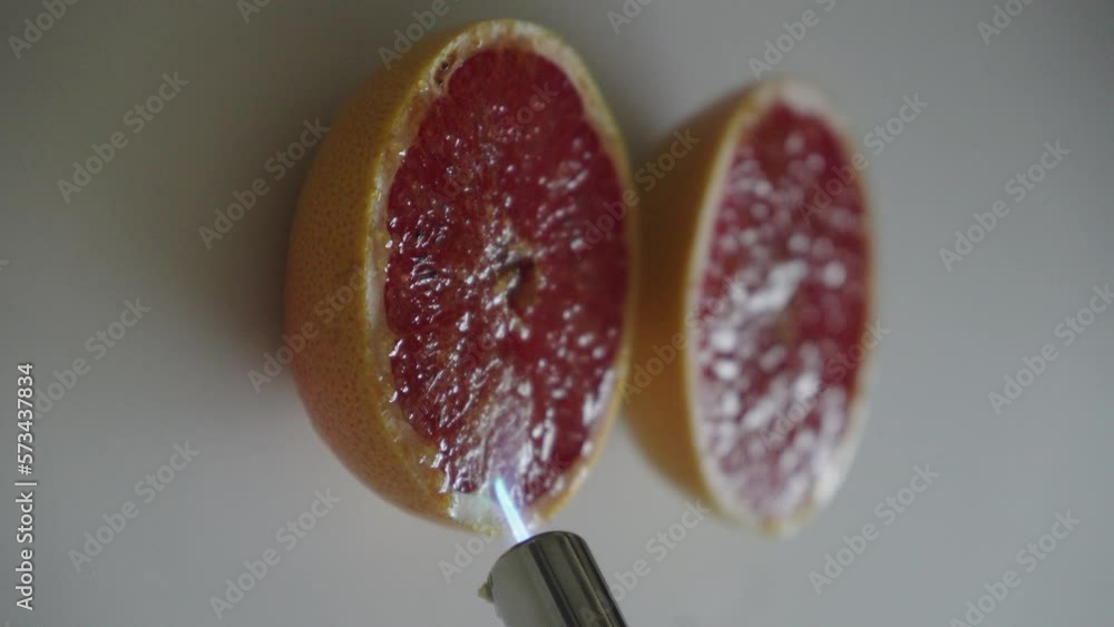 Caramelizing Sugar On The Top Of grapefruit Using Gas Torch Close Up 4K