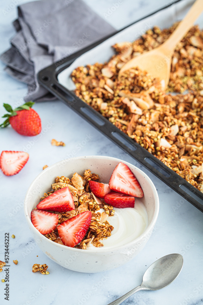 Homemade green buckwheat and nuts granola with coconut yogurt and strawberries in breakfast bowl. Healthy alternative food concept. Homemade green buckwheat and nuts granola with coconut yogurt and strawberries in breakfast bowl. Healthy alternative food concept.