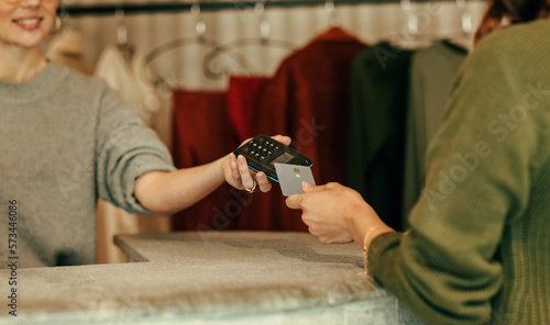 Unrecognizable female customer paying with a credit card