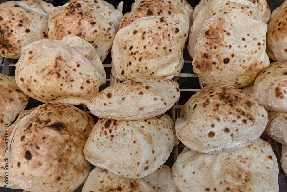 Freshly oven baked traditional Baladi flat bread, similar to pitta bread is a staple of Egyptian cuisine is cooked all over Egypt