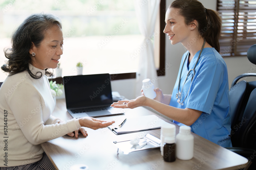 Portrait of a female doctor giving medicine to an elderly patient. Portrait of a female doctor giving medicine to an elderly patient.