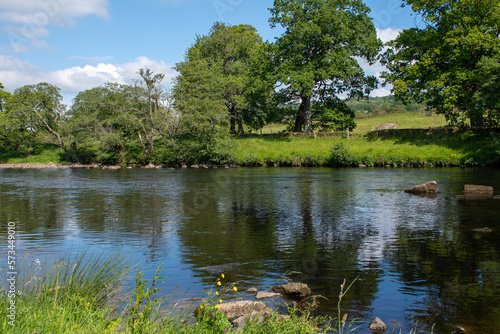 A sunny summer's day, with blue skies over River North Tyne at Chesters in Northumberland, UK