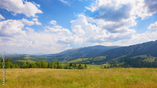Obraz na płótnie nature scenery with hills and meadows. rural valley in the distance. sunny forenoon in summertime. beauty of ukrainian carpathians w salonie