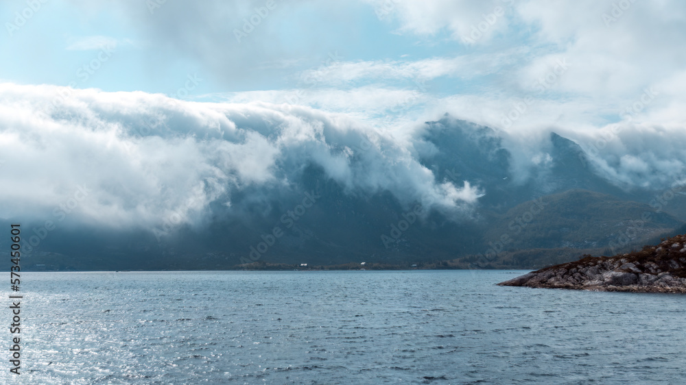 Fog rolling over Mountain Peaks in the Lofoten Archipelago (Norway)