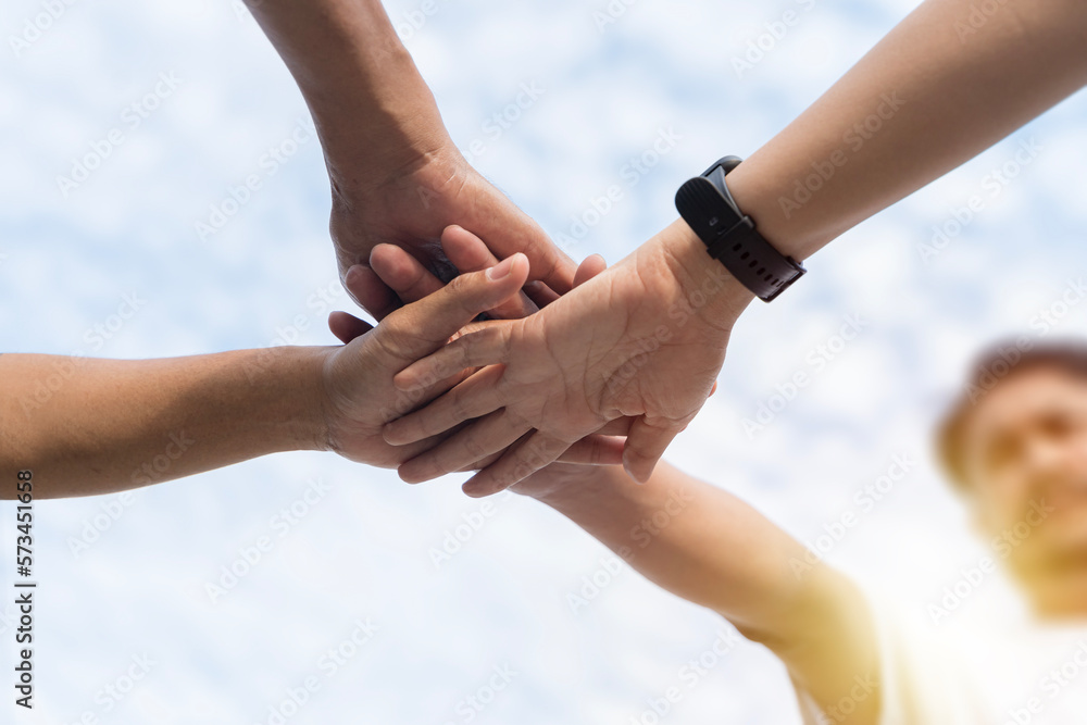 Close up diverse male female sitting holding hands together