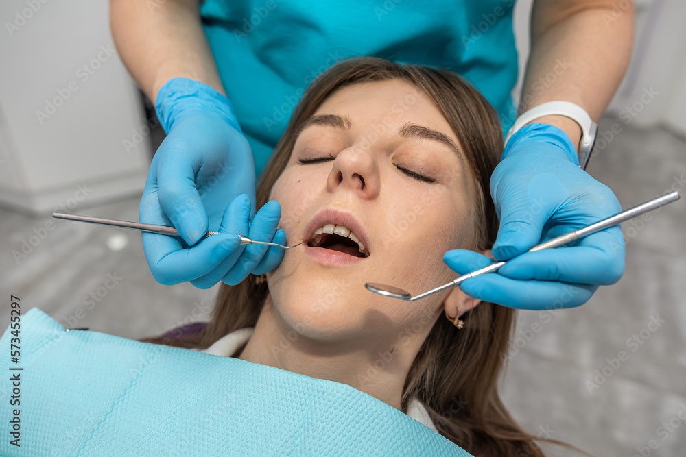 top view of a girl patient who came to check her teeth at the dentist. top view of a girl patient who came to check her teeth at the dentist.