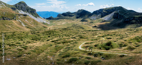 Man and women hiking towards Rifugio dal piaz at Dolomites, Italy photo