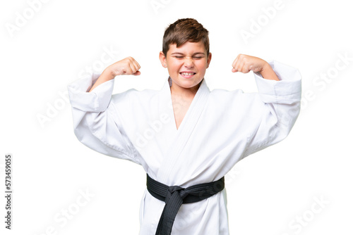 Little caucasian kid doing karate over isolated chroma key background doing strong gesture