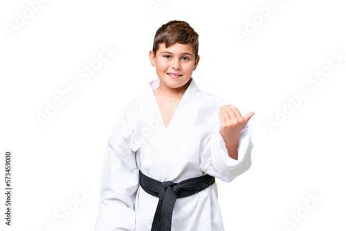 Little caucasian kid doing karate over isolated chroma key background inviting to come with hand. Happy that you came