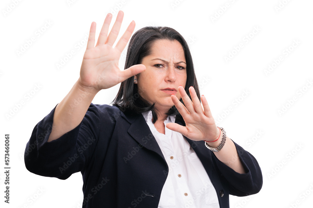 Scared businesswoman making stay away gesture with palms Scared businesswoman making stay away gesture with palms