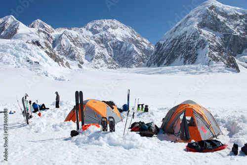 A team of mountaineers is resting in their camp with tents on the lower Kahiltna glacier on their way to Mount McKinley in Alaska. photo