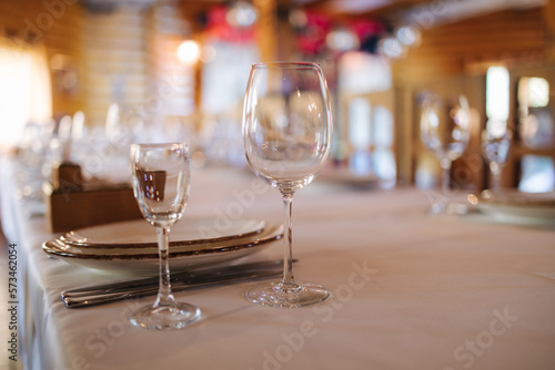Cutlery and glasses on the table in restaurant. Side view