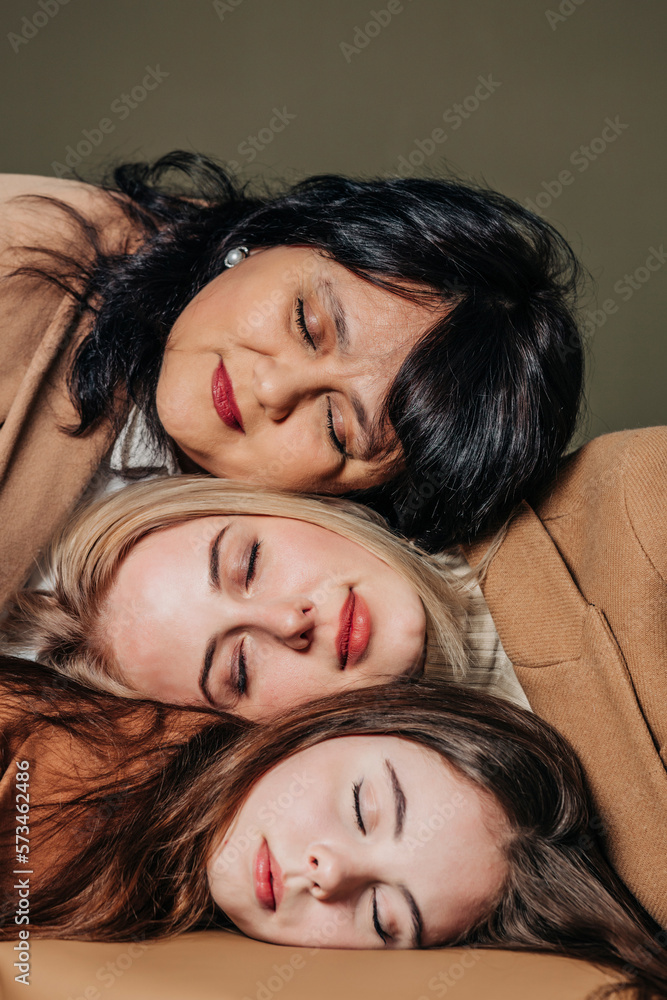 Teenage girl with woman and mother leaning head on each other Teenage girl with woman and mother leaning head on each other