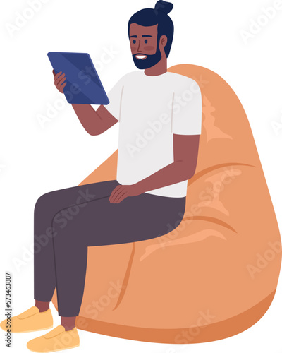 Happy man with tablet sitting on beanbag chair semi flat color vector character. Editable figure. Full body person on white. Simple cartoon style illustration for web graphic design and animation