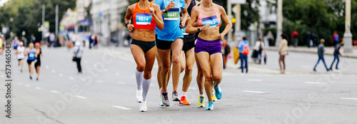 leading group women runners running city marathon race