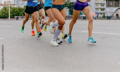 legs runners athletes women and men run city marathon