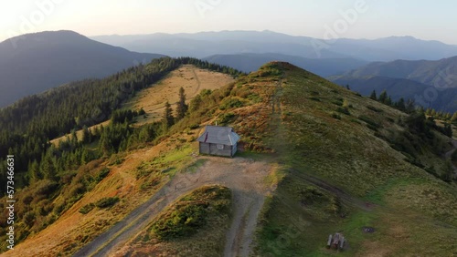 4k drone flight point of view (Ultra High Definition) of old tourist shelter. Colorful autumn scene of Carpathian mountains, Ukraine, Europe. Beauty of nature concept background. photo