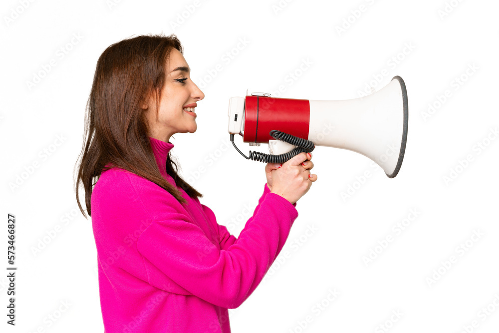 Young caucasian woman over isolated chroma key background shouting through a megaphone Young caucasian woman over isolated chroma key background shouting through a megaphone