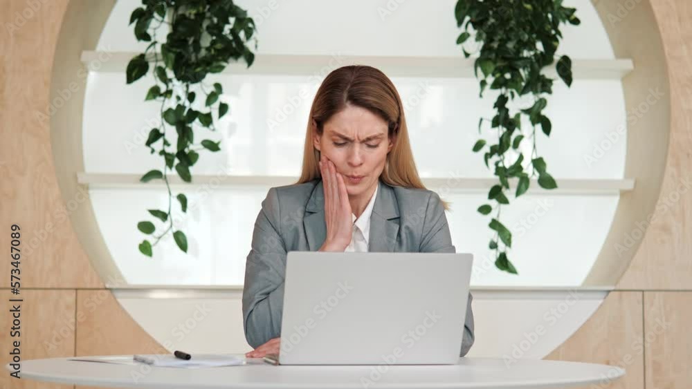 Toothache. Unhappy business woman touch cheek, suffers from toothache, girl having terrible sudden tooth pain, need dental treatment, sitting in office, medical insurance tooth disease concept. Toothache. Unhappy business woman touch cheek, suffers from toothache, girl having terrible sudden tooth pain, need dental treatment, sitting in office, medical insurance tooth disease concept.