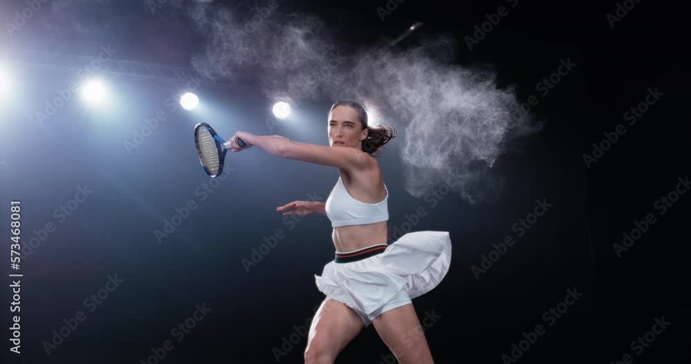 Aesthetic Shot of an Athletic Female Tennis Player with a Black Background Hitting the Ball Under Spotlights. Cinematic Super Slow Motion Captures a Winning Strong Forehand Shot with Smokey Effect Aesthetic Shot of an Athletic Female Tennis Player with a Black Background Hitting the Ball Under Spotlights. Cinematic Super Slow Motion Captures a Winning Strong Forehand Shot with Smokey Effect