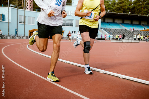 two man athletes run on track stadium marathon race © sports photos