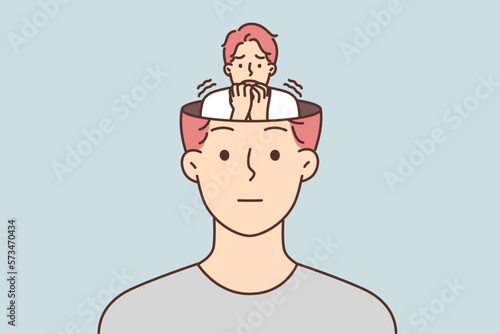 Frightened human sits in head of calm man hiding fear and emotions from others