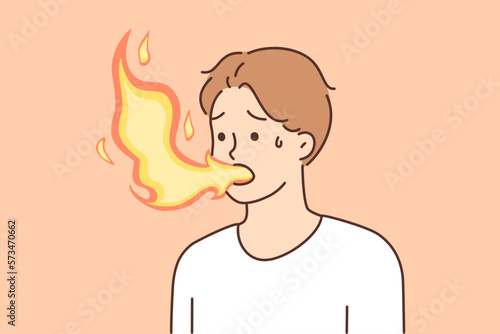 Sick man with flame coming out of mouth suffers from heartburn due to problems