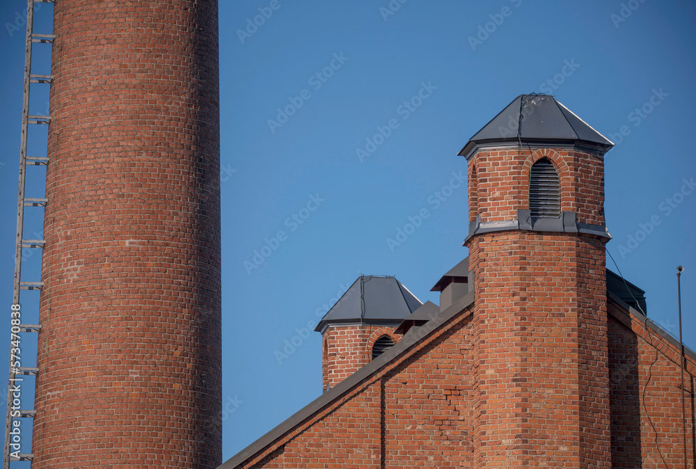 Brick façade and chimneys of an old factory, a winter day in Stockholm