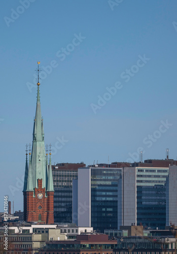 Church tower and skyscrapers in down town, a winter day in Stockholm