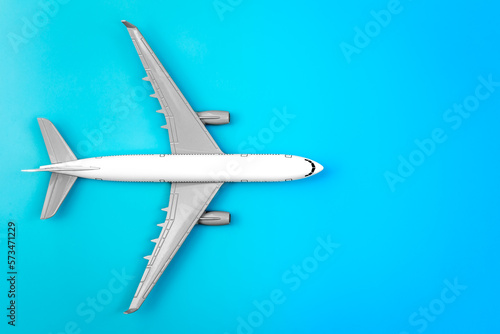 White plane, airplane on a blue background, flat lay, copy space. © puhimec
