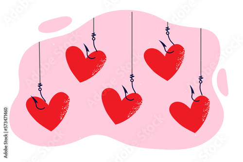Red hearts hanging on hooks of fishing rods as metaphor for traps for people seeking relationships