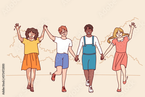 Friends teenagers diversity nationalities and races walk in park holding hands enjoying friendship and spending summer holidays together. Multiethnic boys and girls for concept diversity in society 