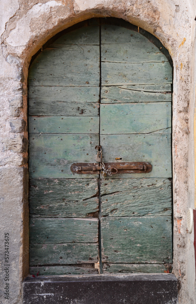 Old wooden door of a house in rural areas of Italy