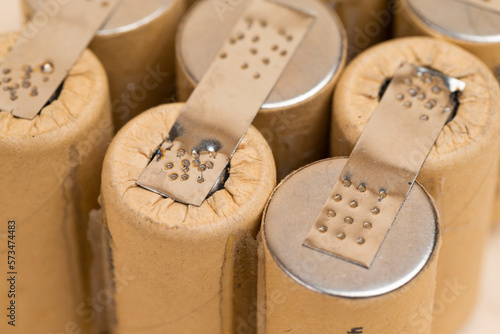 Energy and Environment Ideas. Closeup of Bundle of Soldered Ni-Mh Rechargeable Batteries  Placed Together Over Beige