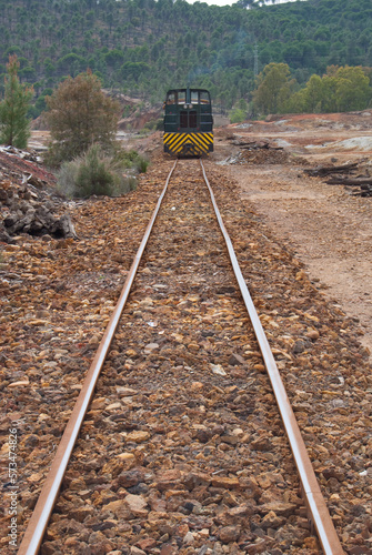 old diesel train approaching from the road of goods from the mines of Rio Tinto