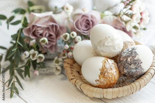 Easter composition with decorative eggs and flowers, close-up.