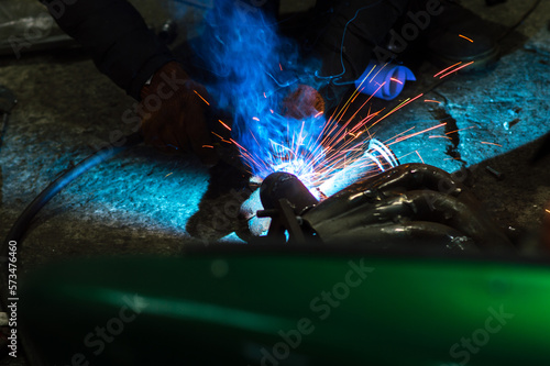  welder performs welding works of metal structures for custom cars