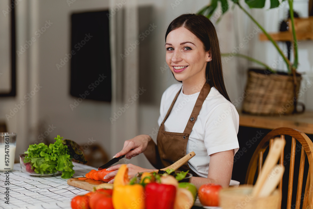 Young Healthy woman cooking healthy food in the kitchen at home. Healthy lifestyle, food, diet concept.