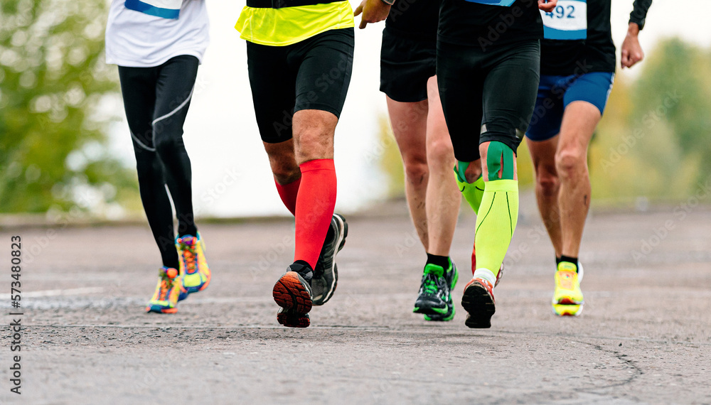 legs male runners in compression socks and kinesio tape run marathon legs male runners in compression socks and kinesio tape run marathon