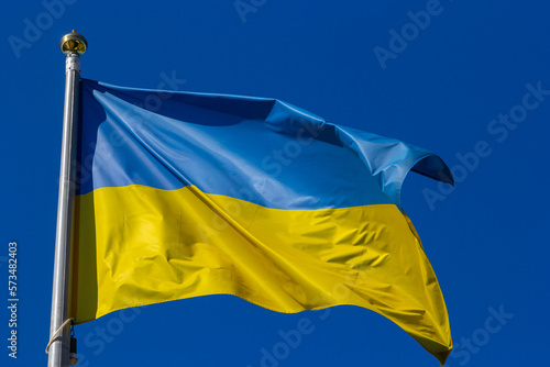 National flag of Ukraine against blue sky, The wind blows out