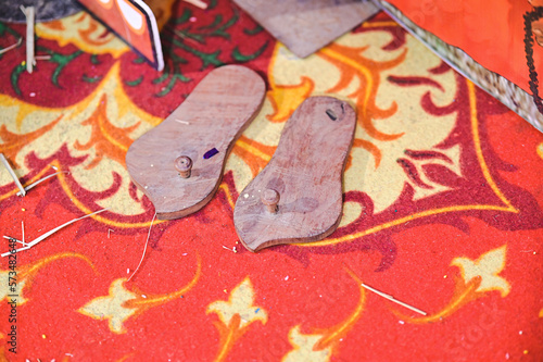 Traditional Hindu Wooden Sandals. Paduka. Maharashtra Culture. Indian Boy Traditional Shoes in Ceremony photo
