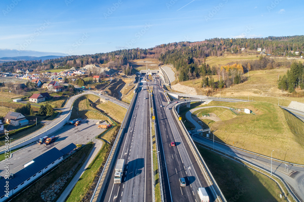 Poland. Zakopianka highway with newly opened tunnel in November 2022. It makes travel from Krakow to Zakopane and Slovakia much faster. Multilevel crossroad with viaducts, slip roads and traffic