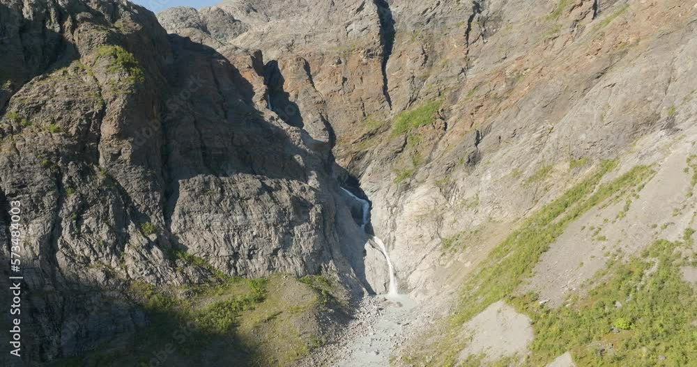 Steep Canyons With Cascading On A Sunny Day With Lyngen Alps Near Tromso, Norway. Aerial Shot Steep Canyons With Cascading On A Sunny Day With Lyngen Alps Near Tromso, Norway. Aerial Shot