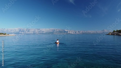 person paddling on the sea