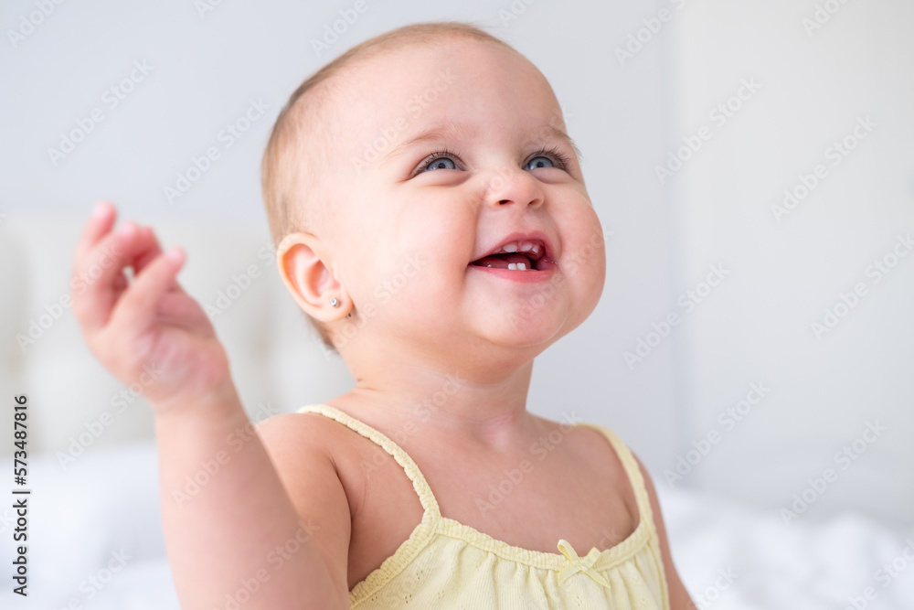 portrait of cute baby girl smiling with first milk teeth. Healthy newborn child portrait of cute baby girl smiling with first milk teeth. Healthy newborn child